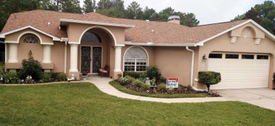 tan stucco home with a new roof in central Florida