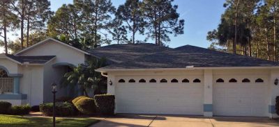 new roof on a white stucco home with blue trim in central Florida