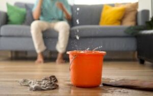 roof leak emergency bucket catching water drips