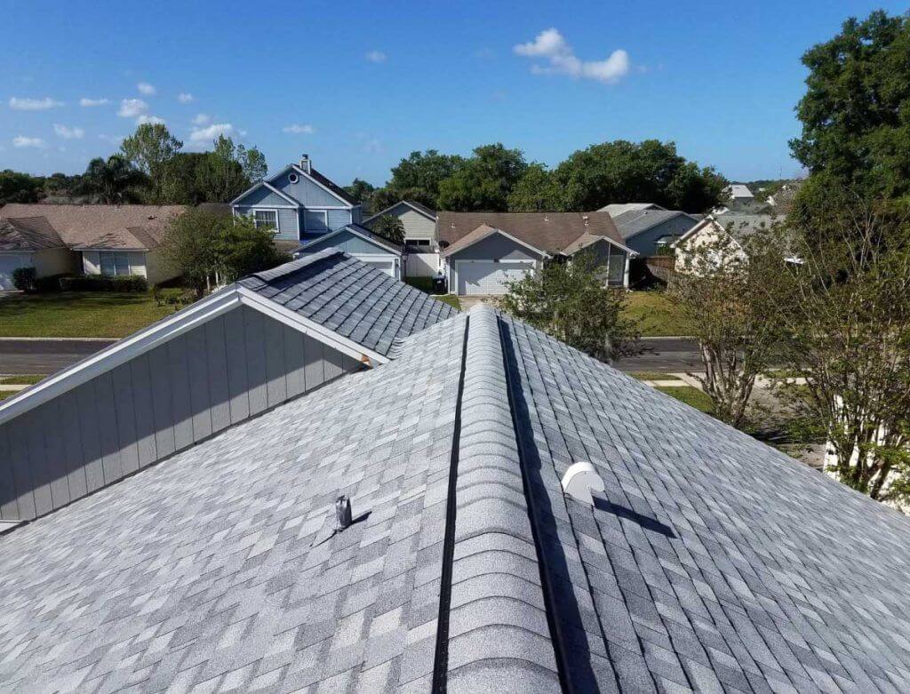 view from the top of a new shingle roof on a home in a residential area.