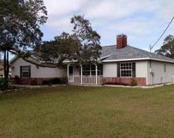 White House With New Roof Installed by the local roofing company; Alan's Roofing in Longwood, FL.