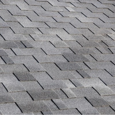 Close-up view of asphalt shingles showing uniform pattern and mineral granules