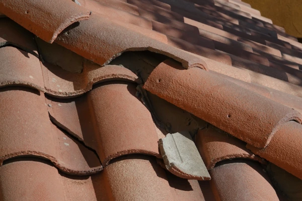 Cracked concrete tile roofing showing damage that preventive maintenance helps catch early