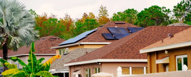 Florida homes with brown asphalt shingle roofs, one with rooftop solar panels